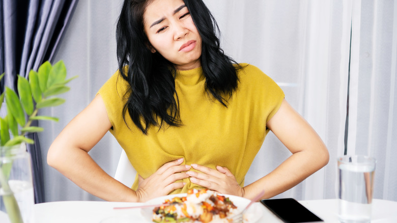 Woman's stomach pain from eating