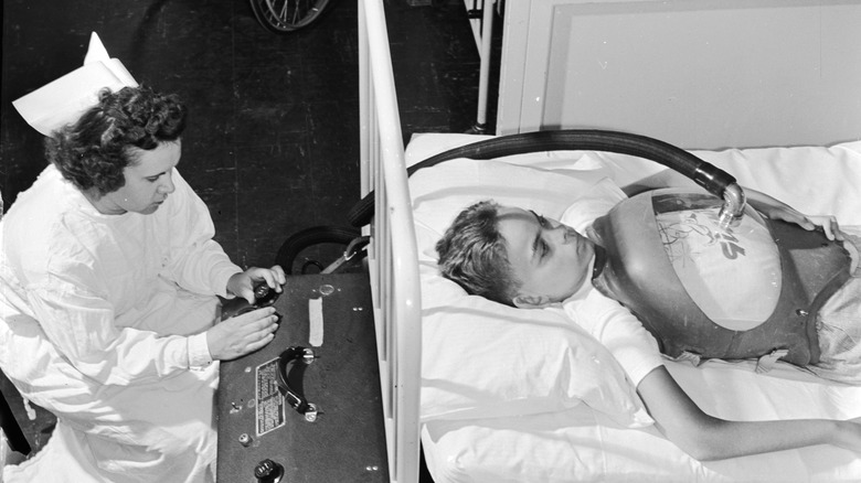 patient and nurse with iron lung