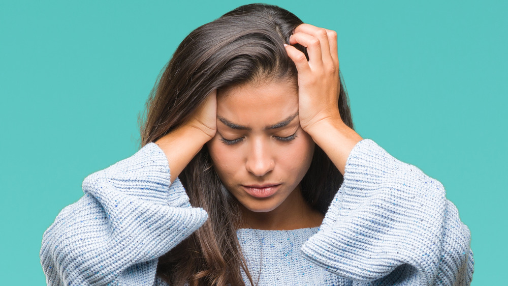 woman with hands on head