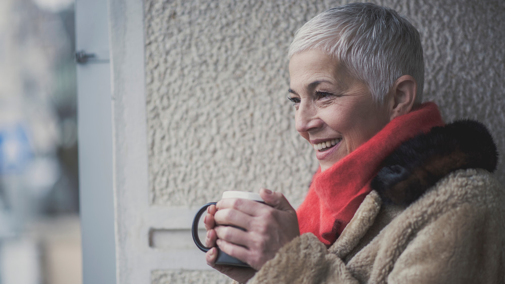 older woman smiling, wrinkles evident