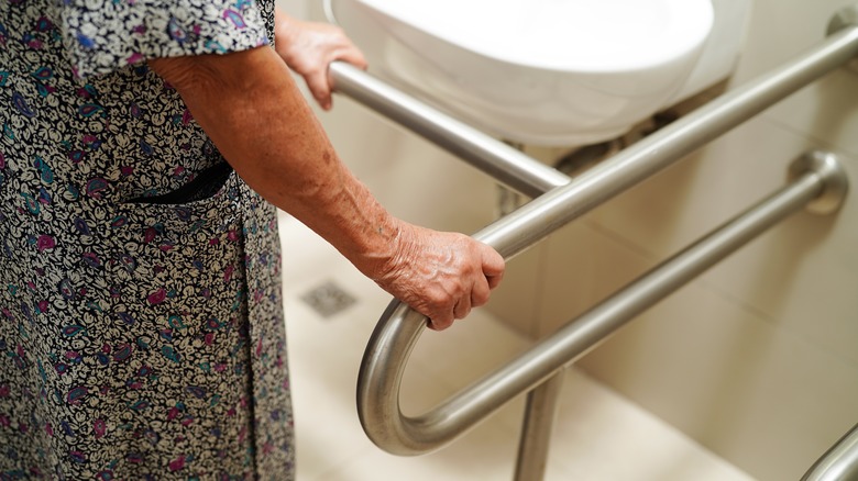 Elderly person using a hospital bathroom