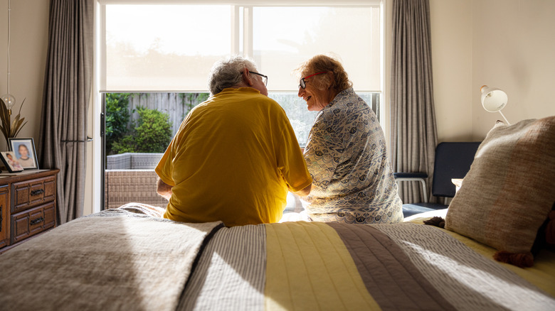 Elderly patients comforting each other in bed