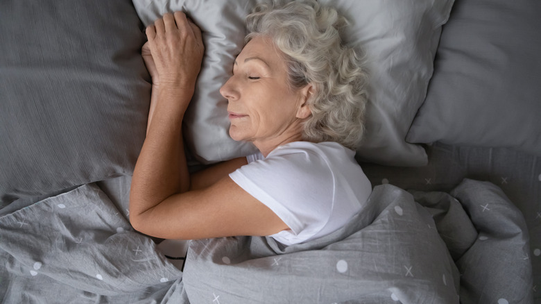 Elderly woman sleeping in bed