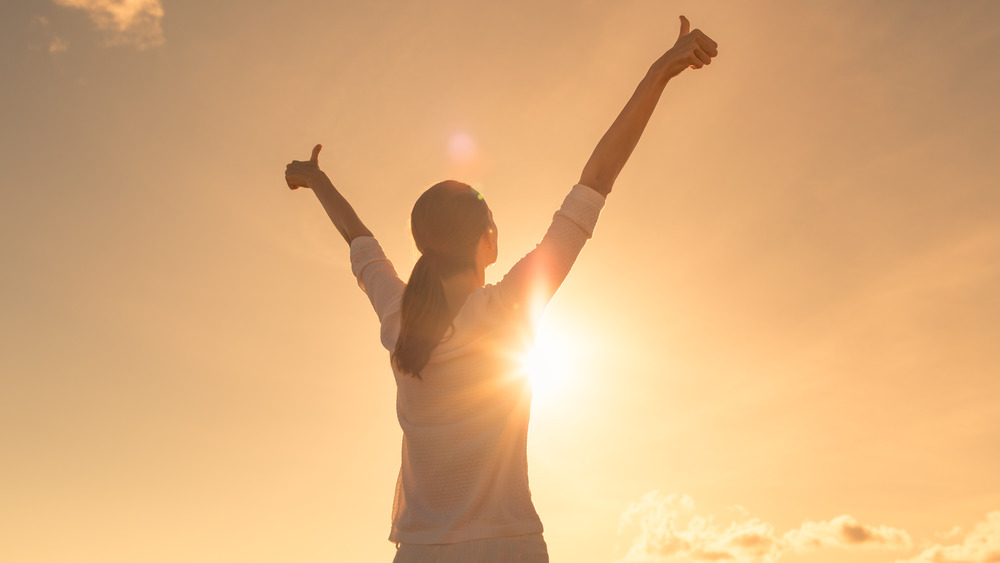 woman stretching in sunlight