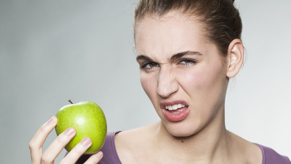 woman holding apple