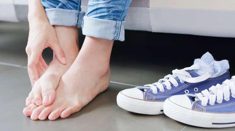 woman scratching feet