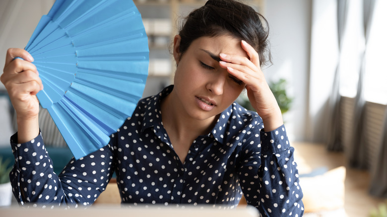 tired woman with fan