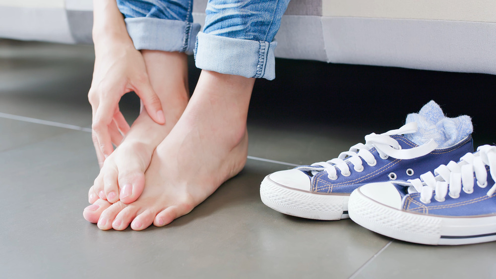 woman scratching feet