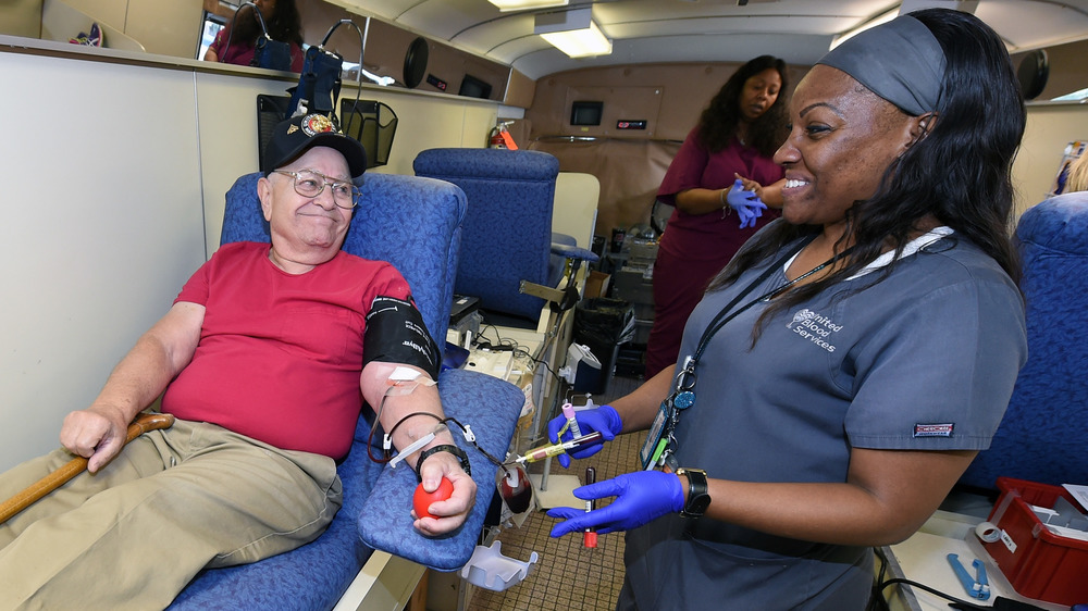 old man donating blood