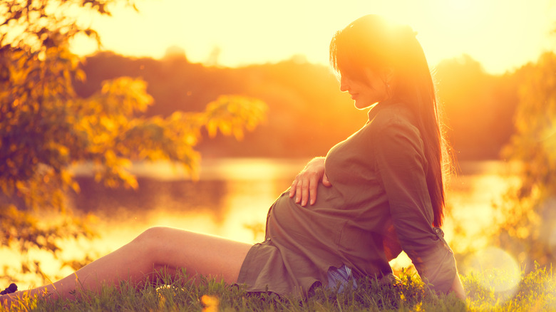 Pregnant woman sitting in the sun