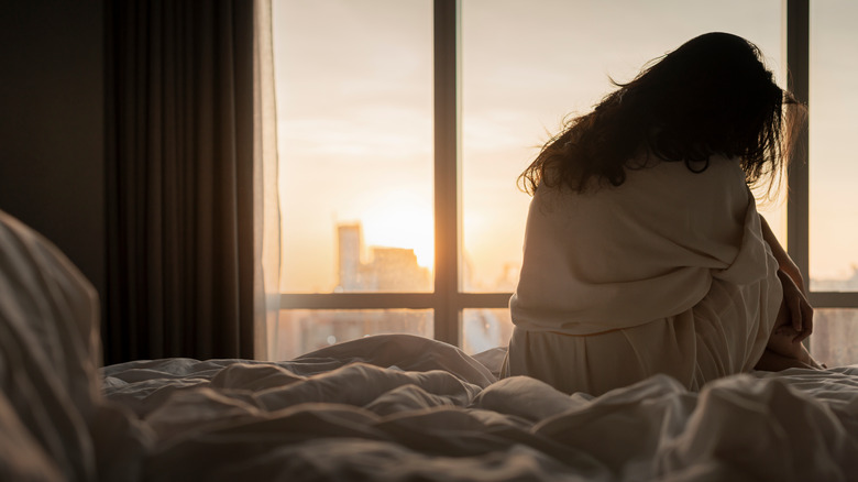 woman on her bed at dawn