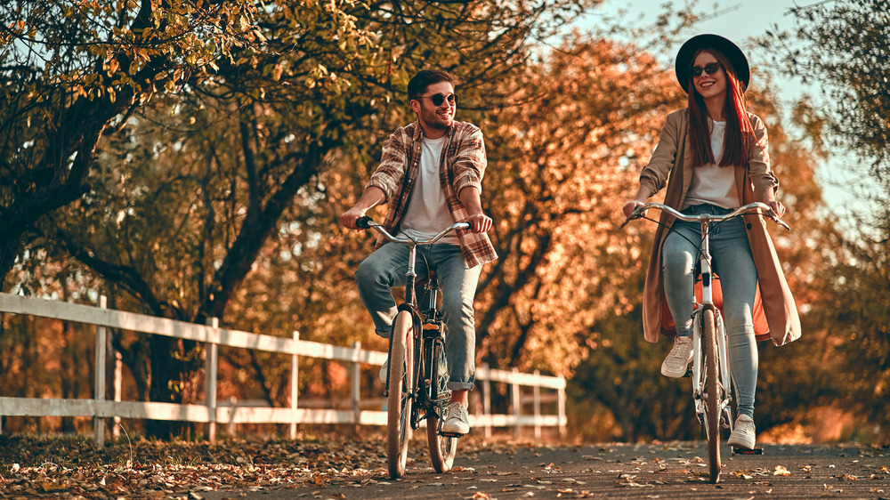 Young couple on bikes in fall