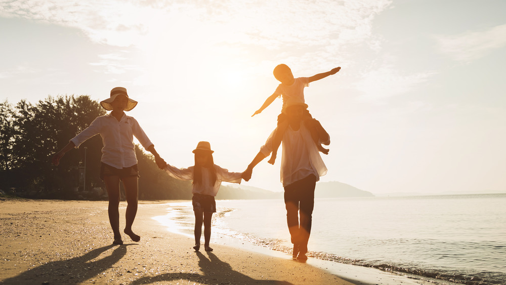 Family happy on beach in the sun