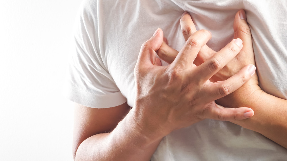 man holding chest