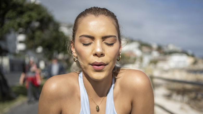 Woman breathing through nose