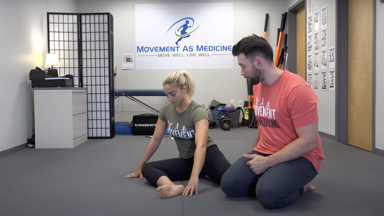 woman doing 90/90 stretch
