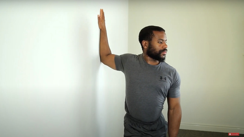 man doing bent-arm wall stretch