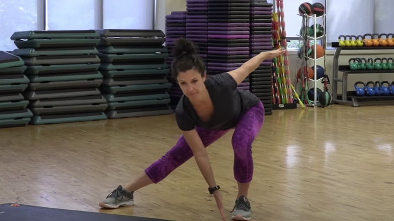 woman doing lateral lunge with reach