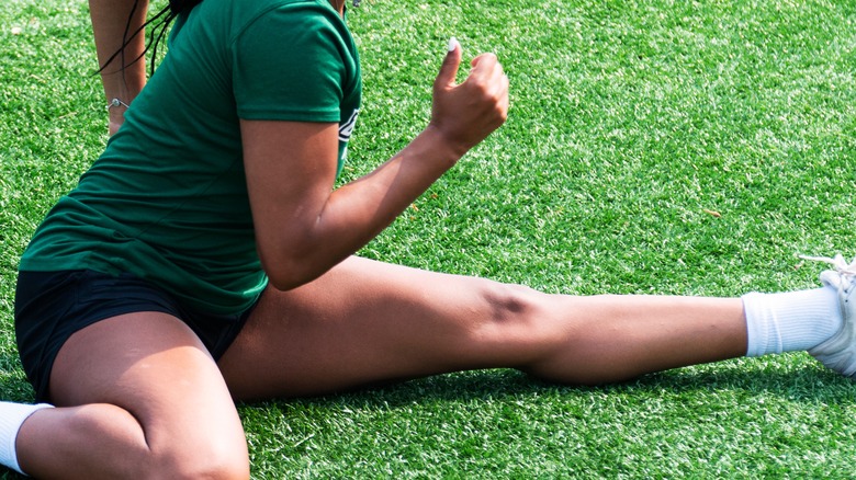 woman doing hurdler stretch