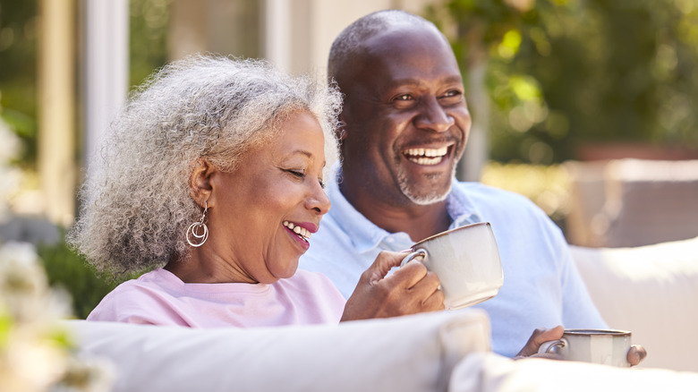 Happy smiling couple sitting outside