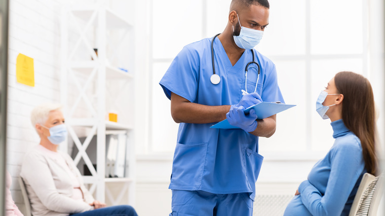 Nurse talks with pregnant patient