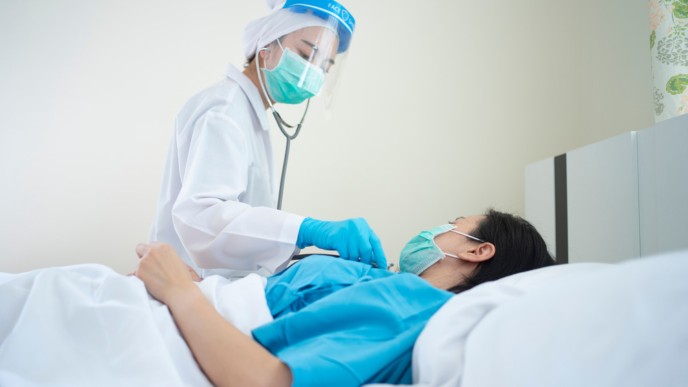 Stock photo of a doctor tending to a COVID patient