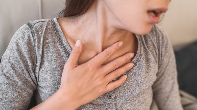 Woman with hand to chest