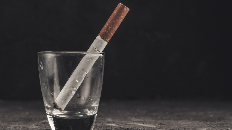 Cigarette in shot glass