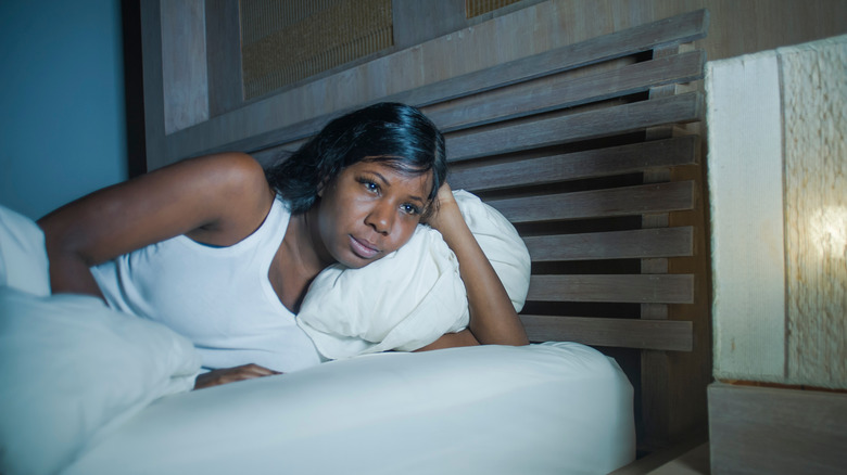 woman lying in bed unable to sleep