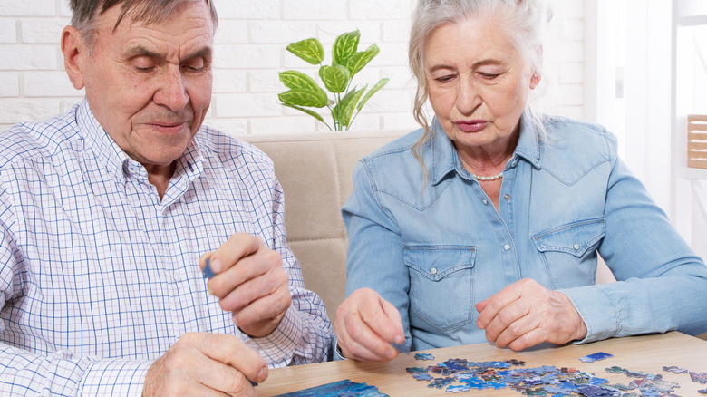 older couple working on puzzle