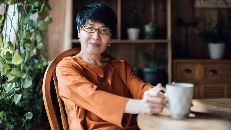 Smiling woman holding tea mug