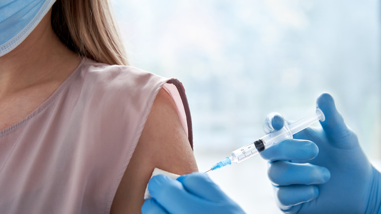 woman receiving vaccine shot in arm