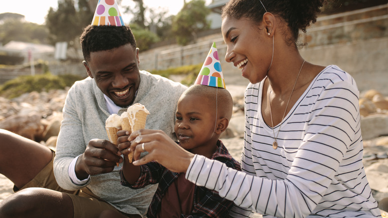 Family celebrating birthday with ice cream cones