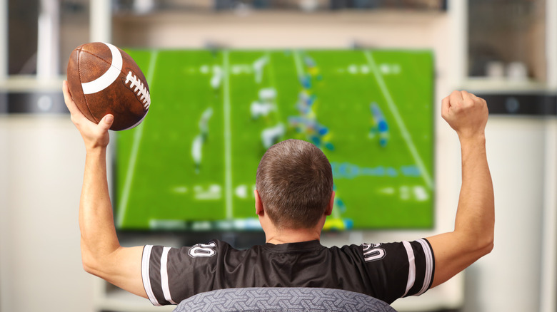 A man cheering during a football game