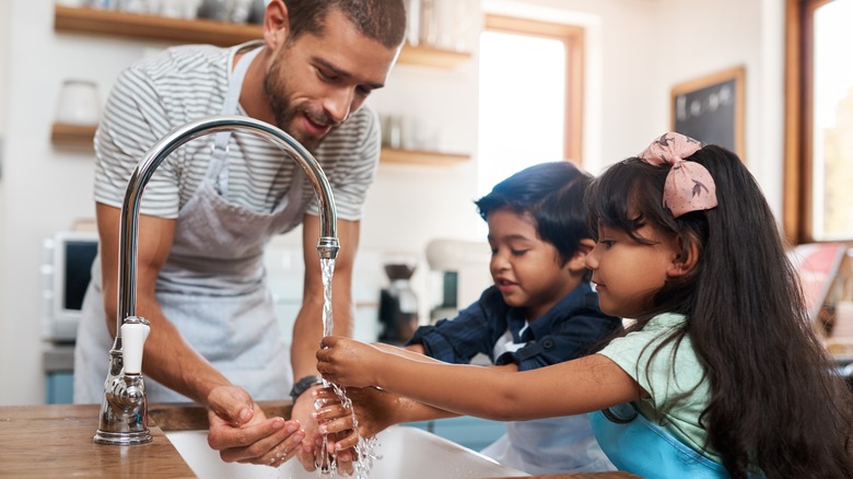 Father and kids washing hands