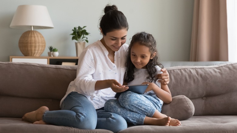 woman and child looking at an iPad