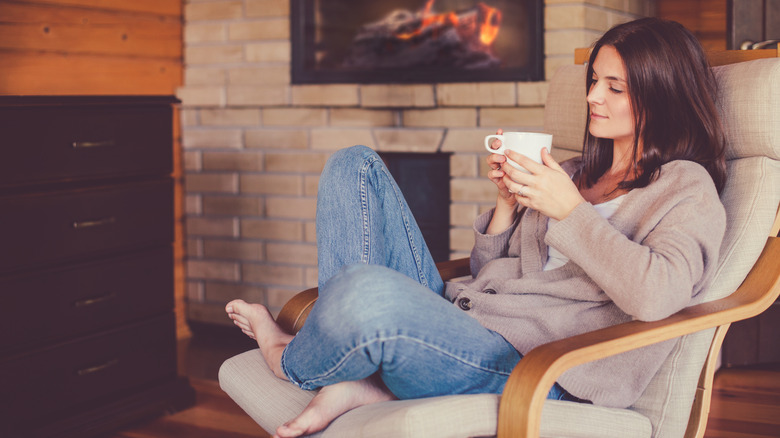 woman relaxing fireplace