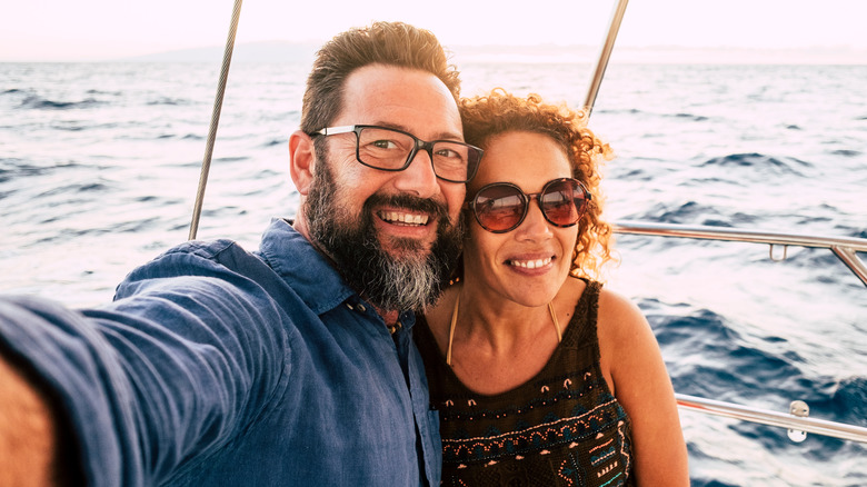 Bearded man with lady in boat - a windy concept