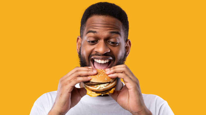 Man about to eat a hamburger