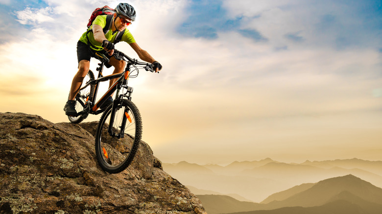 man bicycling down mountain 