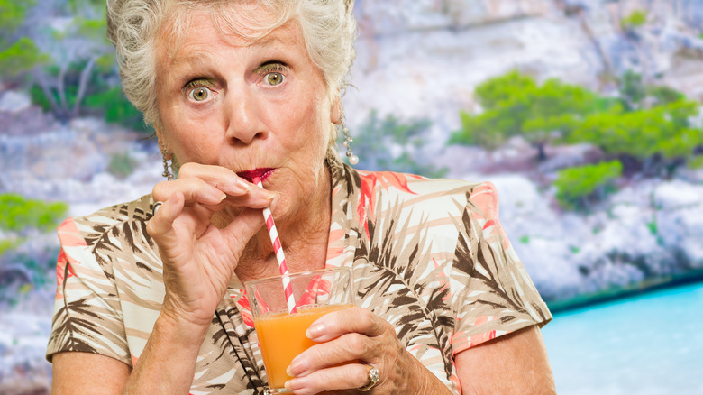 older woman drinking from straw