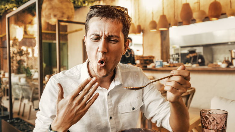 A man eats spicy food