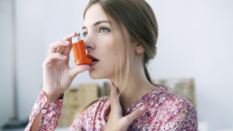 woman using a steroid inhaler