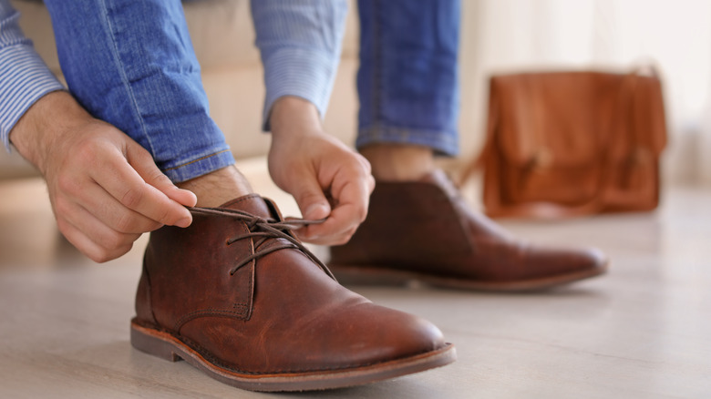 man putting on shoes