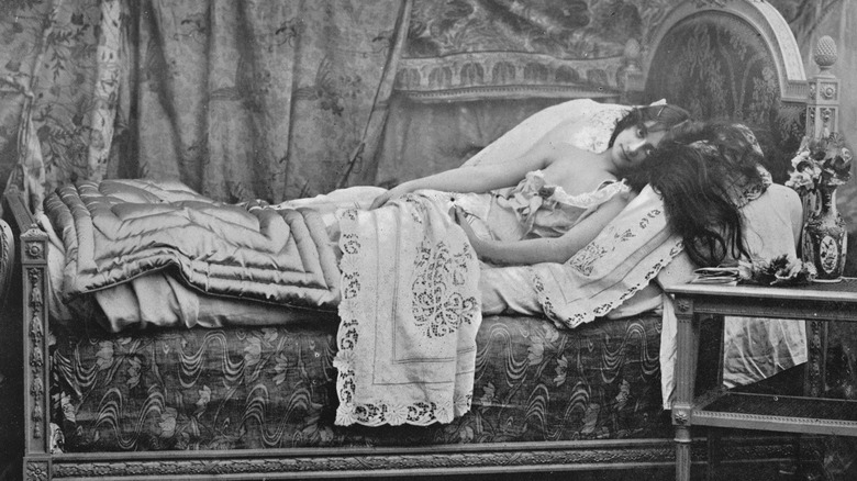 black and white photo of woman in bed