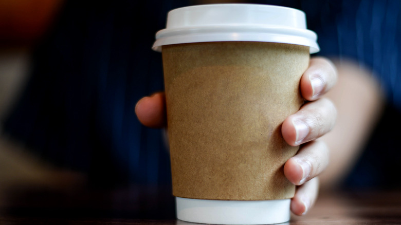 Hand holding coffee cup