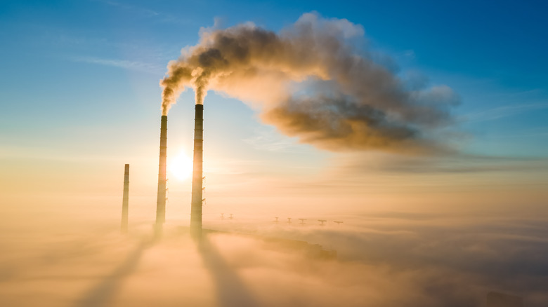 chimneys sending smoke pollutants into atmosphere