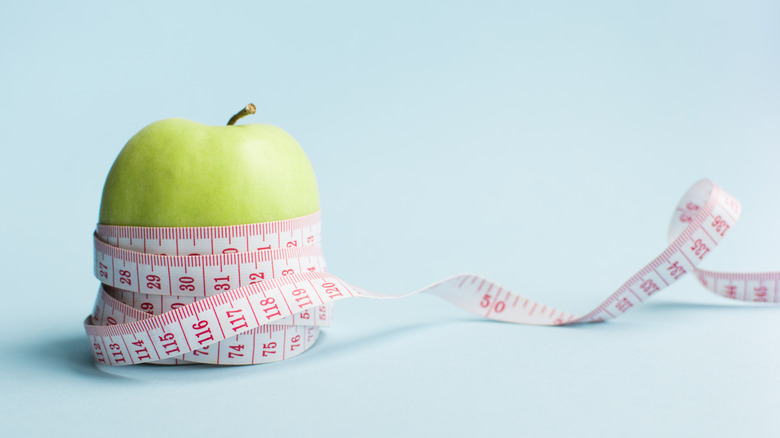 tape measure wrapped around apple