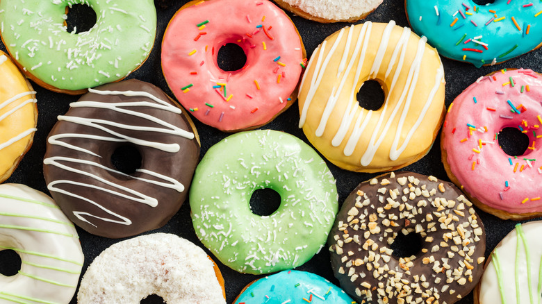 brightly colored donuts on black surface