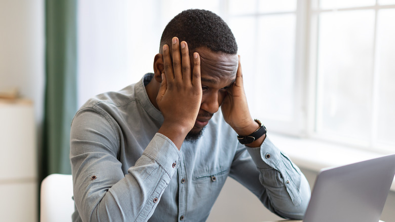 stressed man with hands on face